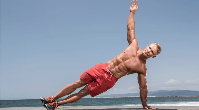 Person doing bodyweight beach workout on sand near the ocean